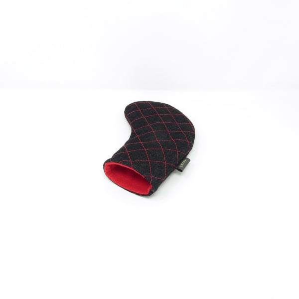 Black quilted hybrid golf club cover with red interior on a white background